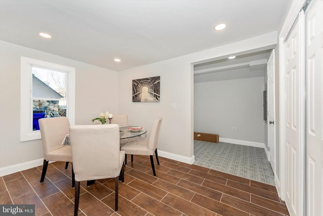 dining space featuring wood finish floors, baseboards, and recessed lighting