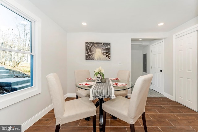 dining space with wood tiled floor, electric panel, baseboards, and recessed lighting