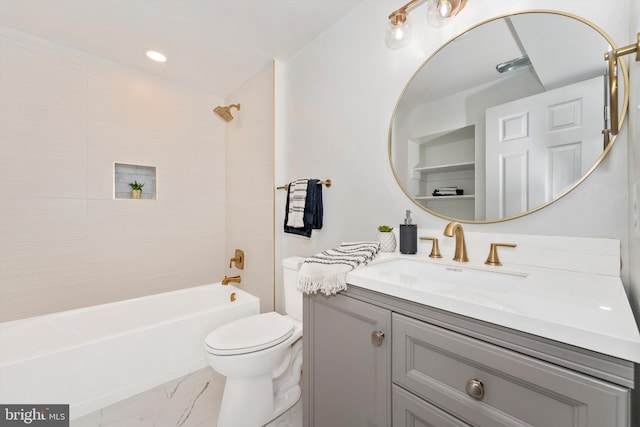 full bathroom featuring toilet, marble finish floor, bathtub / shower combination, and vanity