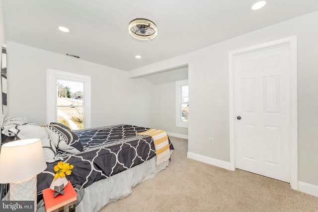 bedroom with baseboards, recessed lighting, and light colored carpet