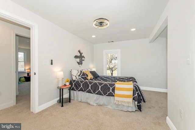 bedroom with light carpet, recessed lighting, and baseboards