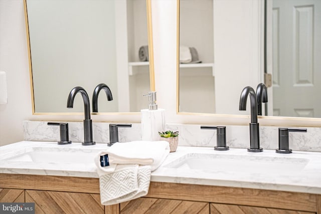 full bath featuring double vanity and a sink