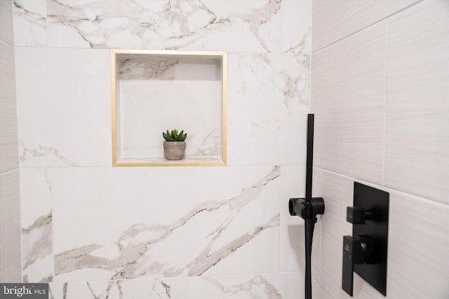 interior details featuring tiled shower