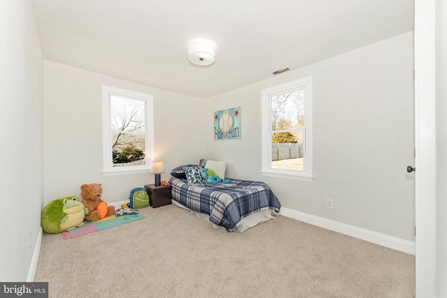 carpeted bedroom featuring baseboards