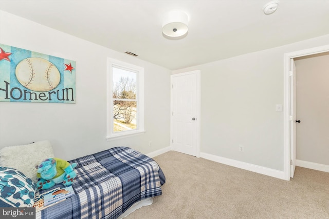 bedroom featuring light carpet, visible vents, and baseboards