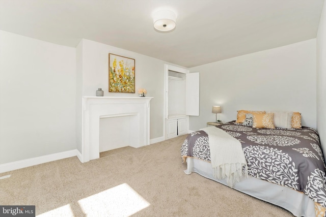 bedroom featuring carpet floors and baseboards