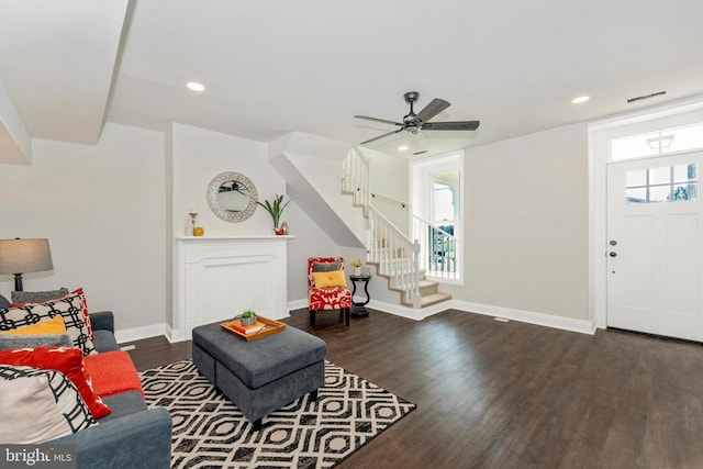 living room featuring dark wood-style flooring, stairway, recessed lighting, and baseboards