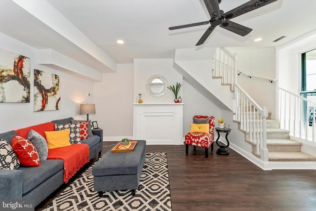 living room with recessed lighting, dark wood-type flooring, visible vents, baseboards, and stairs