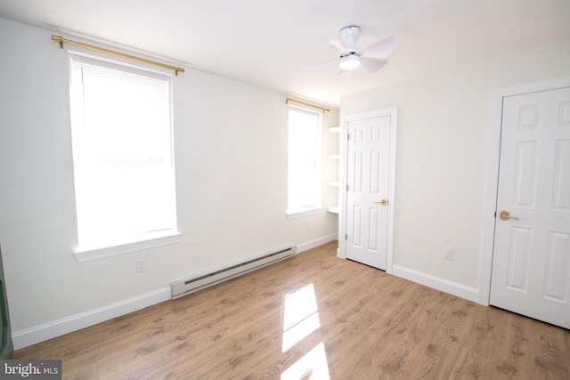 unfurnished bedroom with a baseboard radiator, ceiling fan, light wood-style flooring, and baseboards