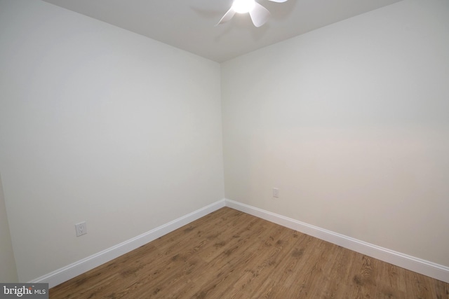 unfurnished room featuring a ceiling fan, baseboards, and wood finished floors