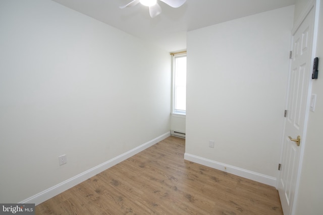 unfurnished bedroom with a ceiling fan, a baseboard radiator, light wood-style flooring, and baseboards