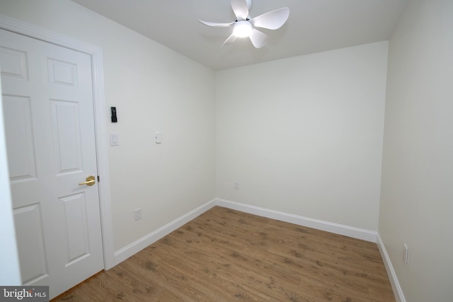 unfurnished room featuring a ceiling fan, baseboards, and wood finished floors