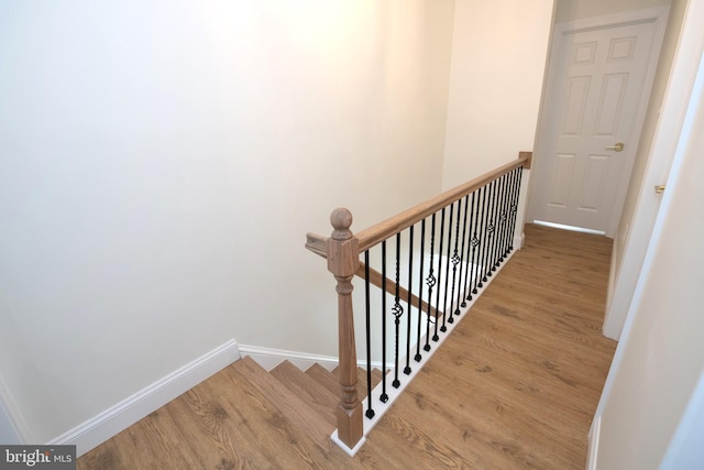 stairs with baseboards and wood finished floors