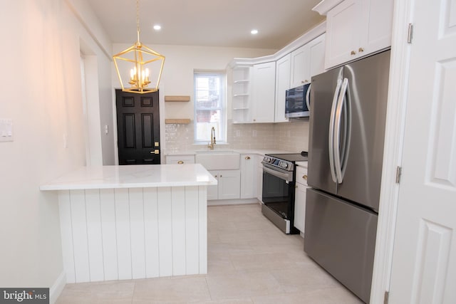 kitchen featuring open shelves, hanging light fixtures, backsplash, appliances with stainless steel finishes, and white cabinetry