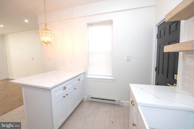 kitchen featuring a peninsula, a baseboard radiator, white cabinetry, and pendant lighting