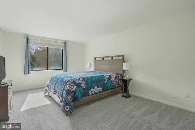 bedroom featuring light carpet and baseboards