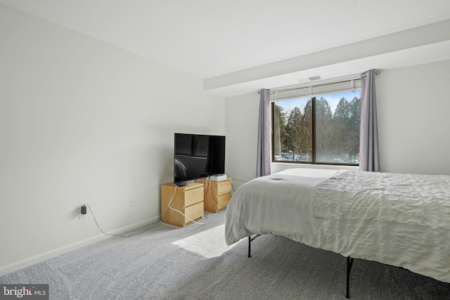 bedroom featuring light colored carpet and baseboards