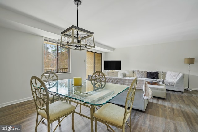 dining space with a chandelier, dark wood-style flooring, and baseboards