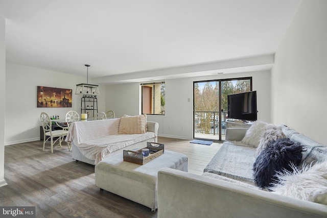 living area with wood finished floors and baseboards