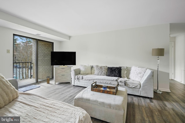 living room featuring visible vents and wood finished floors