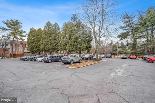 uncovered parking lot featuring fence