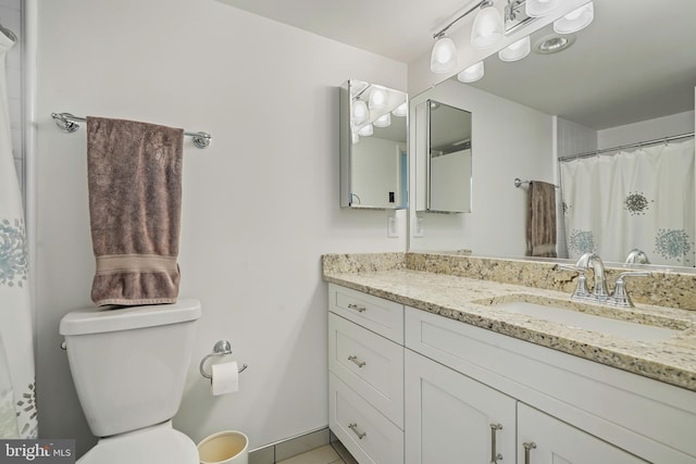 full bathroom with toilet and vanity