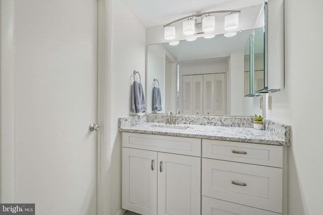 bathroom featuring a closet and vanity