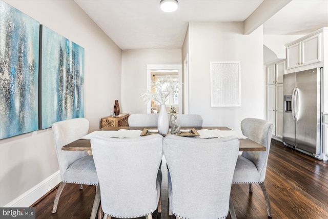 dining area featuring dark wood-style flooring and baseboards