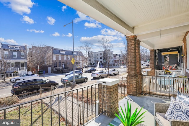 balcony featuring a porch and a residential view