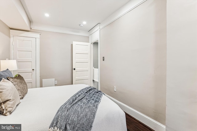 bedroom with recessed lighting, baseboards, and wood finished floors