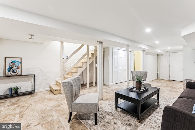 living area featuring baseboards, stairway, and recessed lighting