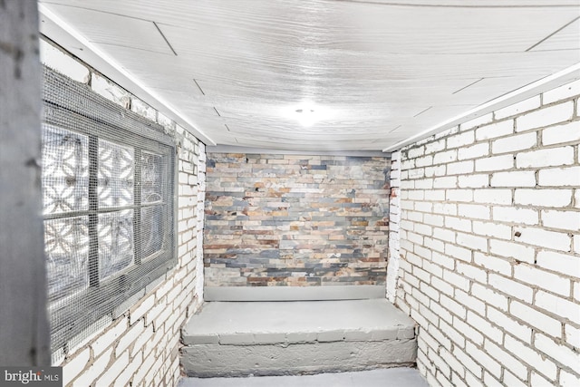 bathroom with brick wall