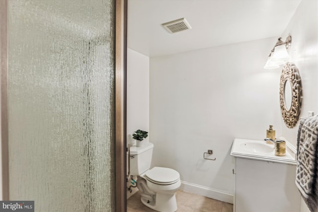 bathroom featuring visible vents, baseboards, toilet, tile patterned flooring, and vanity