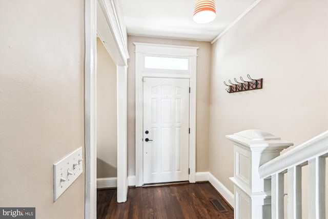 doorway featuring dark wood-type flooring, visible vents, and baseboards