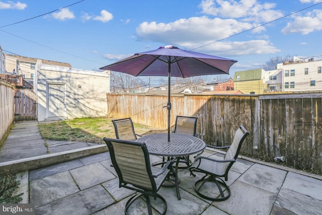 view of patio with outdoor dining area and a fenced backyard