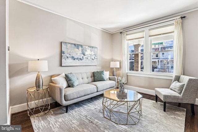 living room with crown molding, wood finished floors, and baseboards