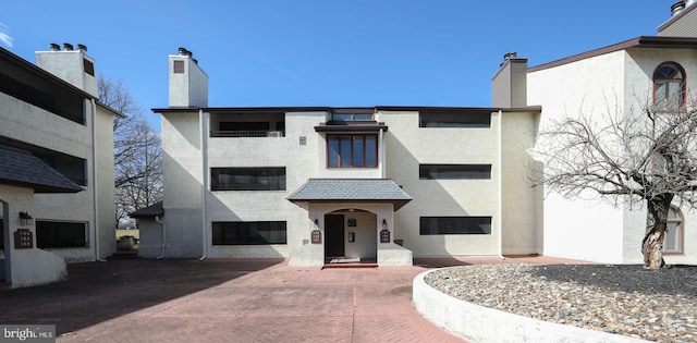 view of property featuring decorative driveway