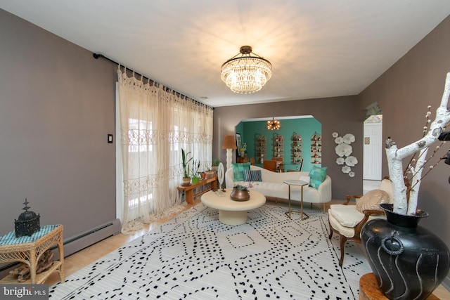 living room with an inviting chandelier and baseboard heating