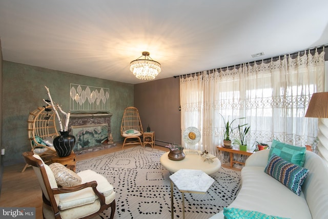 living room featuring an inviting chandelier, visible vents, and wood finished floors