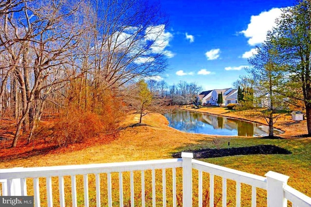 view of yard featuring a water view and fence