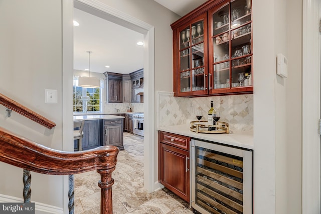 bar with wine cooler, exhaust hood, high end stainless steel range, backsplash, and a dry bar