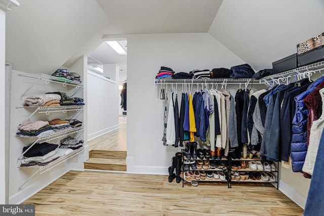 walk in closet featuring lofted ceiling and wood finished floors