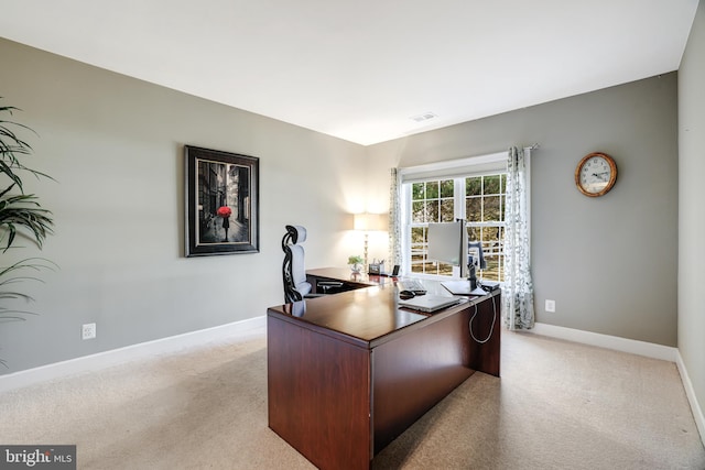 office featuring light carpet, visible vents, and baseboards