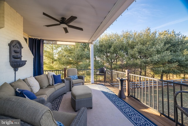 view of patio with ceiling fan, a deck, and an outdoor living space