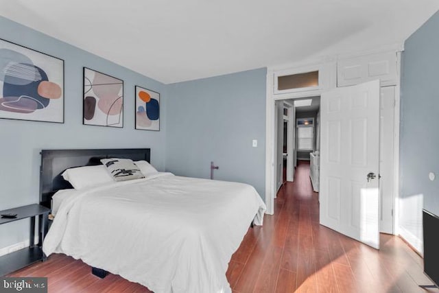 bedroom with dark wood-style flooring