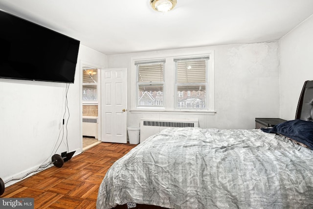 bedroom featuring radiator and multiple windows