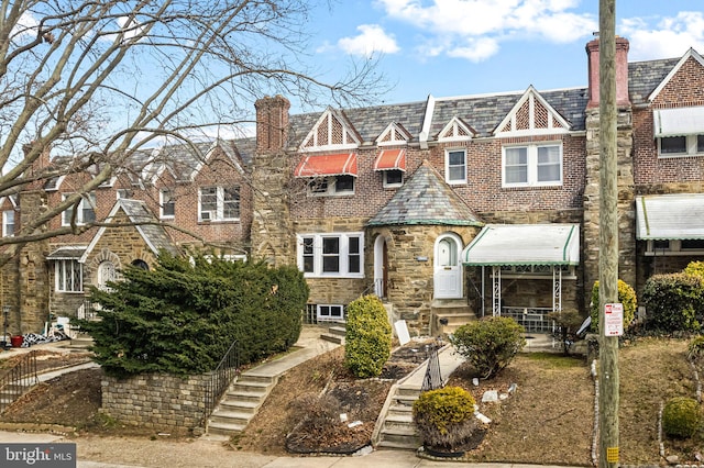 view of front of house featuring a high end roof and a chimney