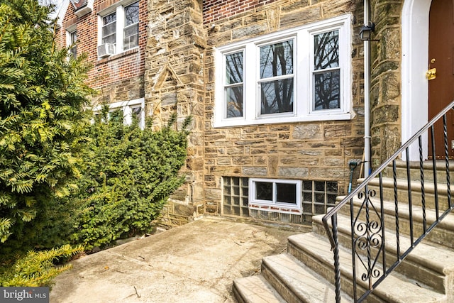 entrance to property with stone siding and brick siding