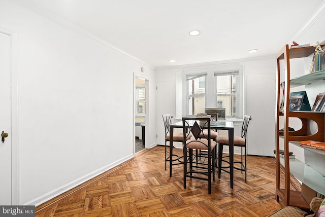 dining space featuring baseboards, crown molding, and recessed lighting