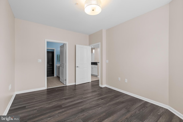 unfurnished bedroom featuring dark wood-style floors and baseboards